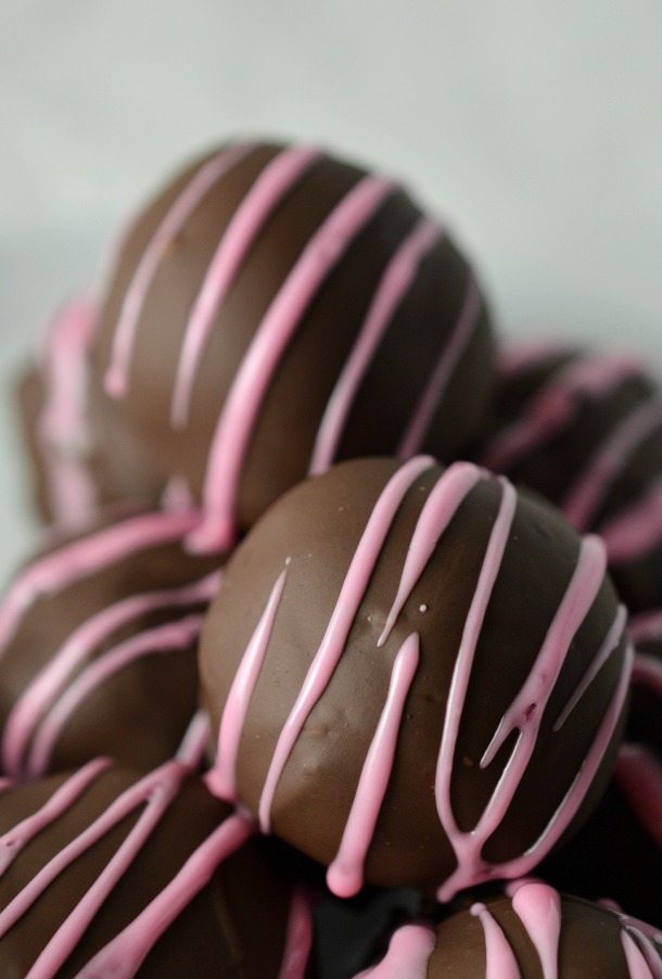 brown chocolate balls with pink drizzled lines