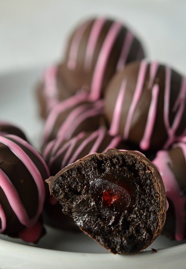 dark brown truffle ball cut in half to show cherry inside