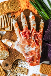 hand shaped cheese ball surrounded by crackers