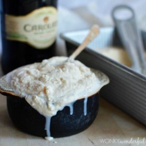 melted ice cream in black dish with Irish cream bottle in background