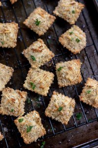 breaded baked ravioli on wire rack and baking sheet