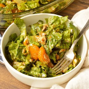 salad in white bowl with fork