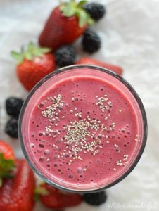 above view of thick dark pink drink topped with chia seeds