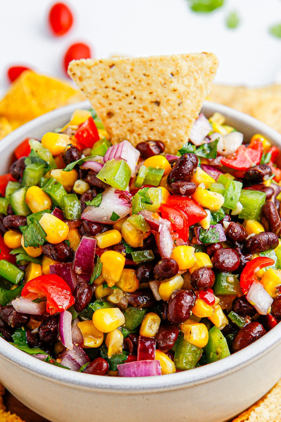 chip in bowl of black bean salsa