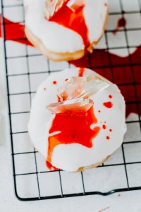 white donuts topped with candy shards and red corn syrup