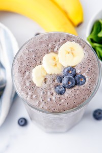 smoothie topped with sliced bananas and blueberries