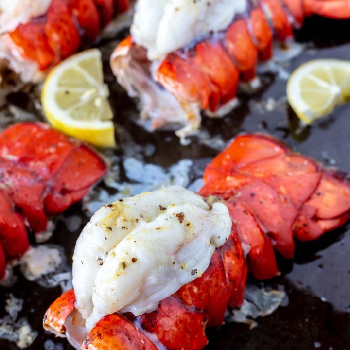 baked lobster tails on rimmed baking sheet