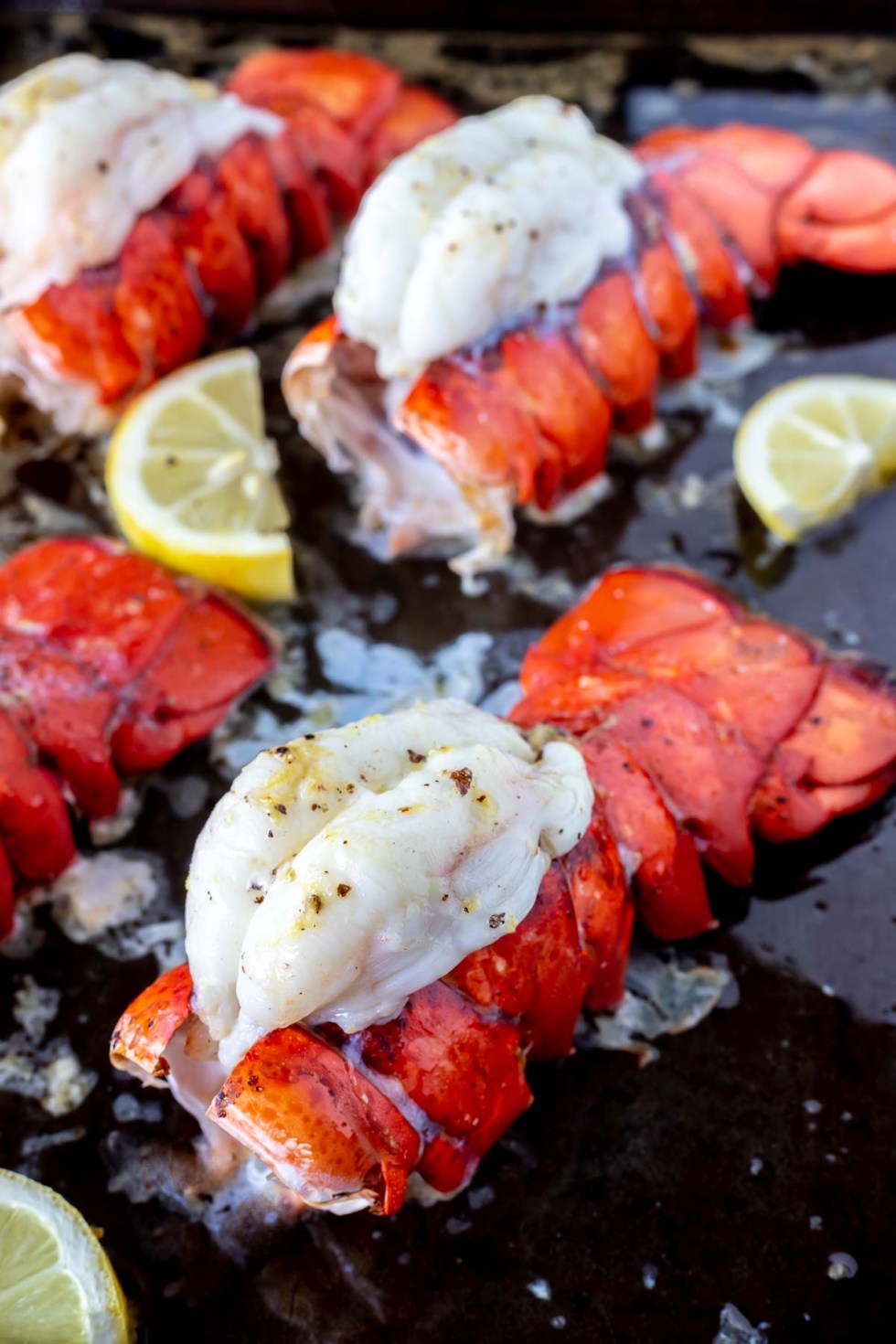 baked lobster tails on rimmed baking sheet