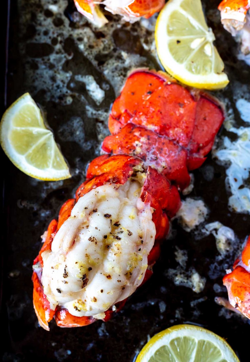 broiled Bobster and lemons on baking sheet