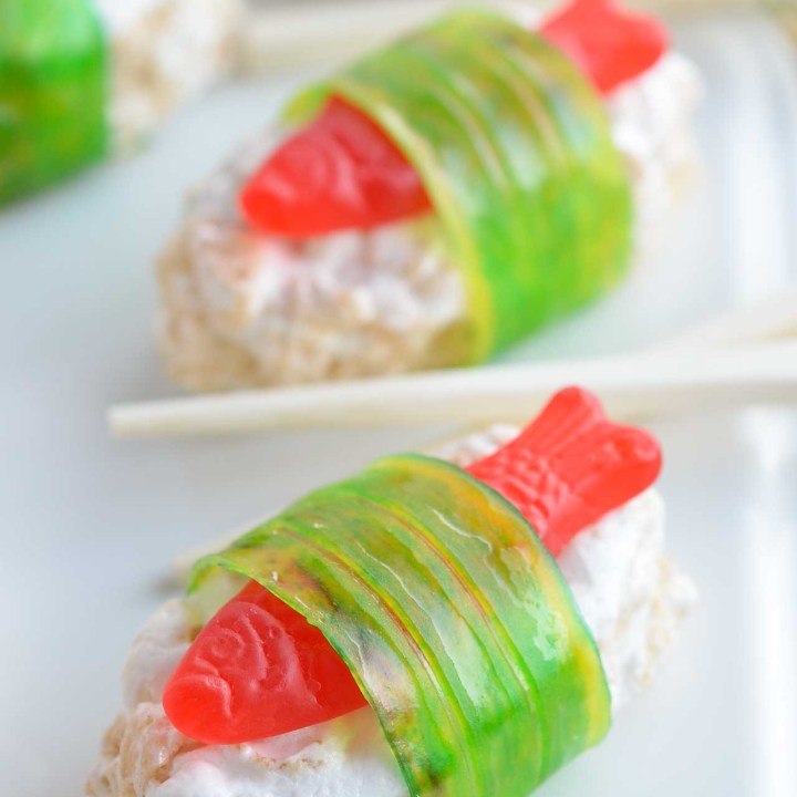 The kids will go crazy for this Candy Sushi! Made with rice crispy treats, Swedish fish candy and fruit roll ups. This dessert sushi recipe is easy to make, portable and great for parties.