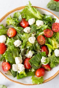 lettuce, mozzarella, basil and tomatoes in bowl