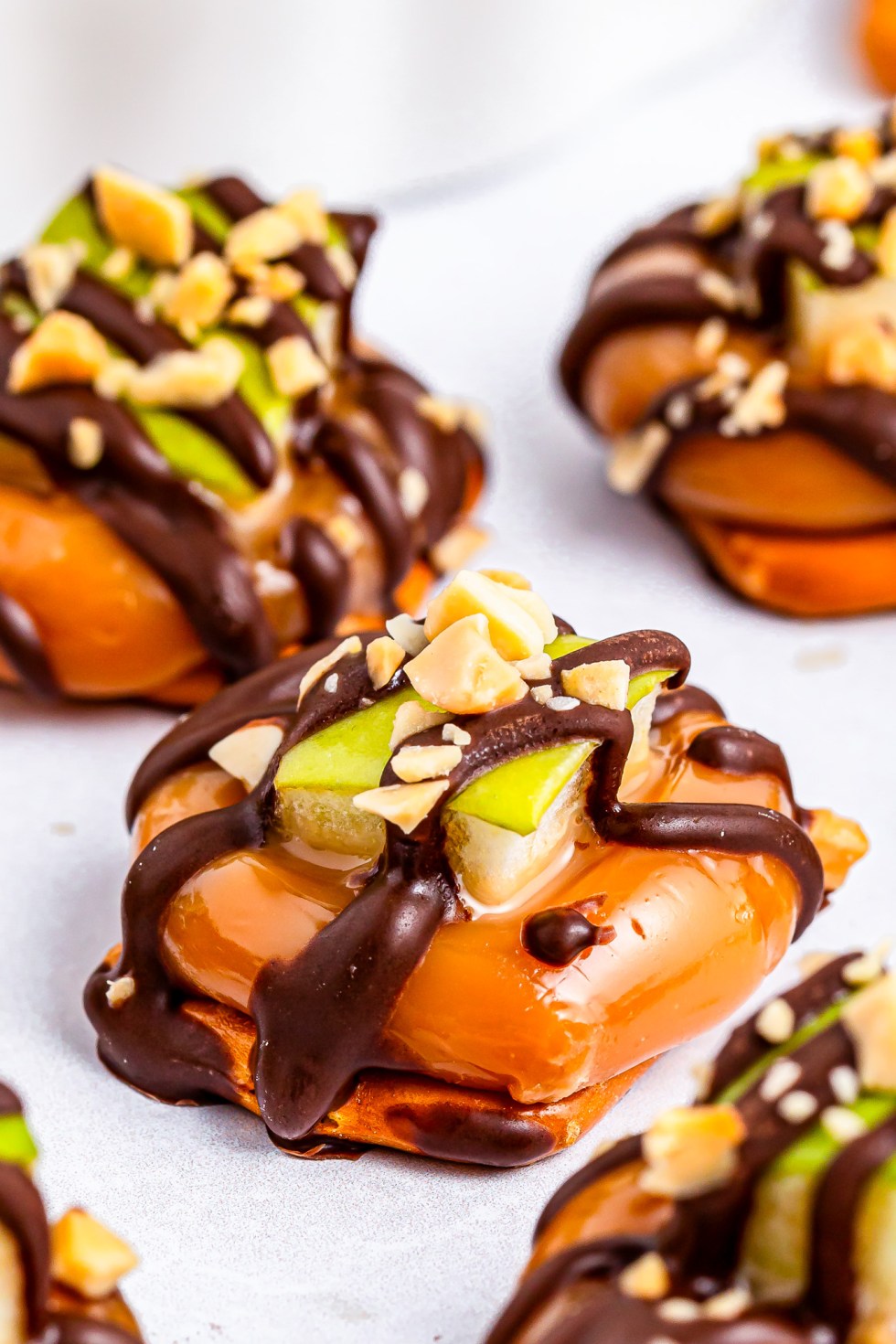 pretzel topped with caramel, apple and chocolate