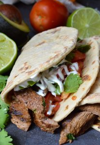 Nothing beats a great Carne Asada Recipe for the summertime grill season! This Carne Asada is made with thinly sliced round tip steak marinated in orange, lime, cilantro and garlic. Perfect for wraps, tacos, burrito bowls or any Mexican food dish you can think of!