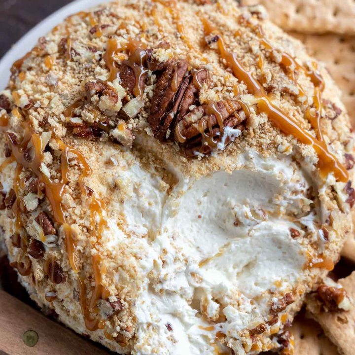 cream cheese ball covered with graham cracker crumbs, chopped pecans and caramel