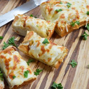 It doesn't get easier than this Cheesy Onion Bread recipe. French bread topped with sweet onions sautéed to golden perfection and mozzarella cheese makes a great appetizer or side dish.