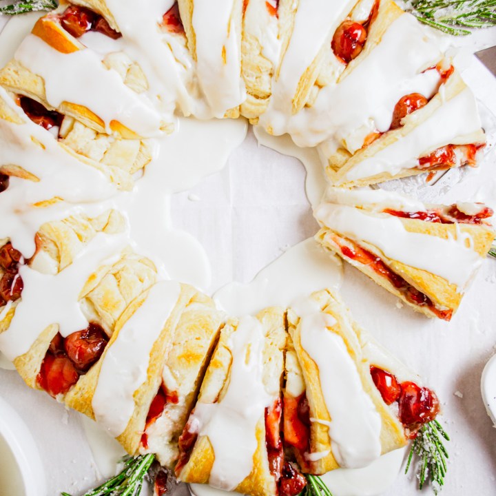 prepared pastry wreath with cherries and rosemary