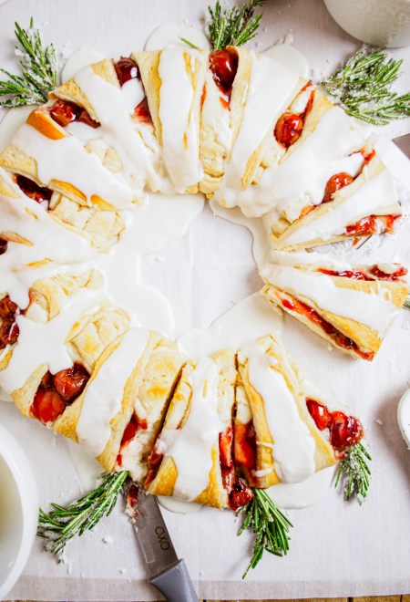 prepared pastry wreath with cherries and rosemary