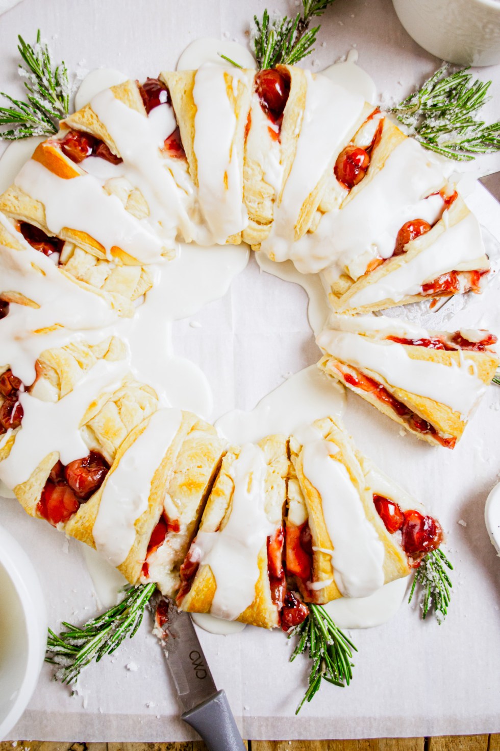 prepared pastry wreath with cherries and rosemary