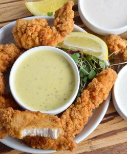 These 3 Unique Dip Recipes are perfect for your game day party spread! Serve these delicious breaded chicken strips with Creamy Lemon Pepper Dip, Honey Mustard Sauce and my Secret Fry Sauce for a guaranteed crowd pleaser!