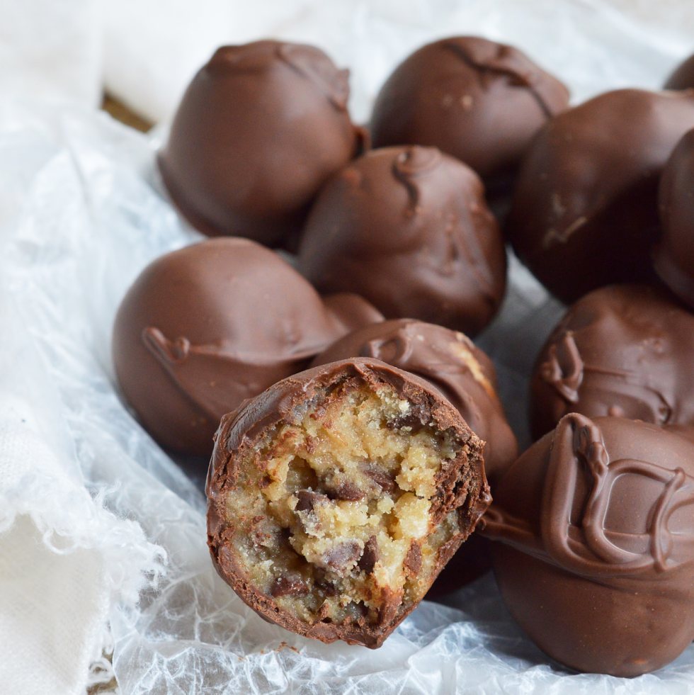 STOP what you're doing and make these Edible Cookie Dough Truffles! Chocolate chip cookie dough that is safe to eat is rolled into balls and coated with chocolate! This no-bake dessert recipe is as good as it gets!