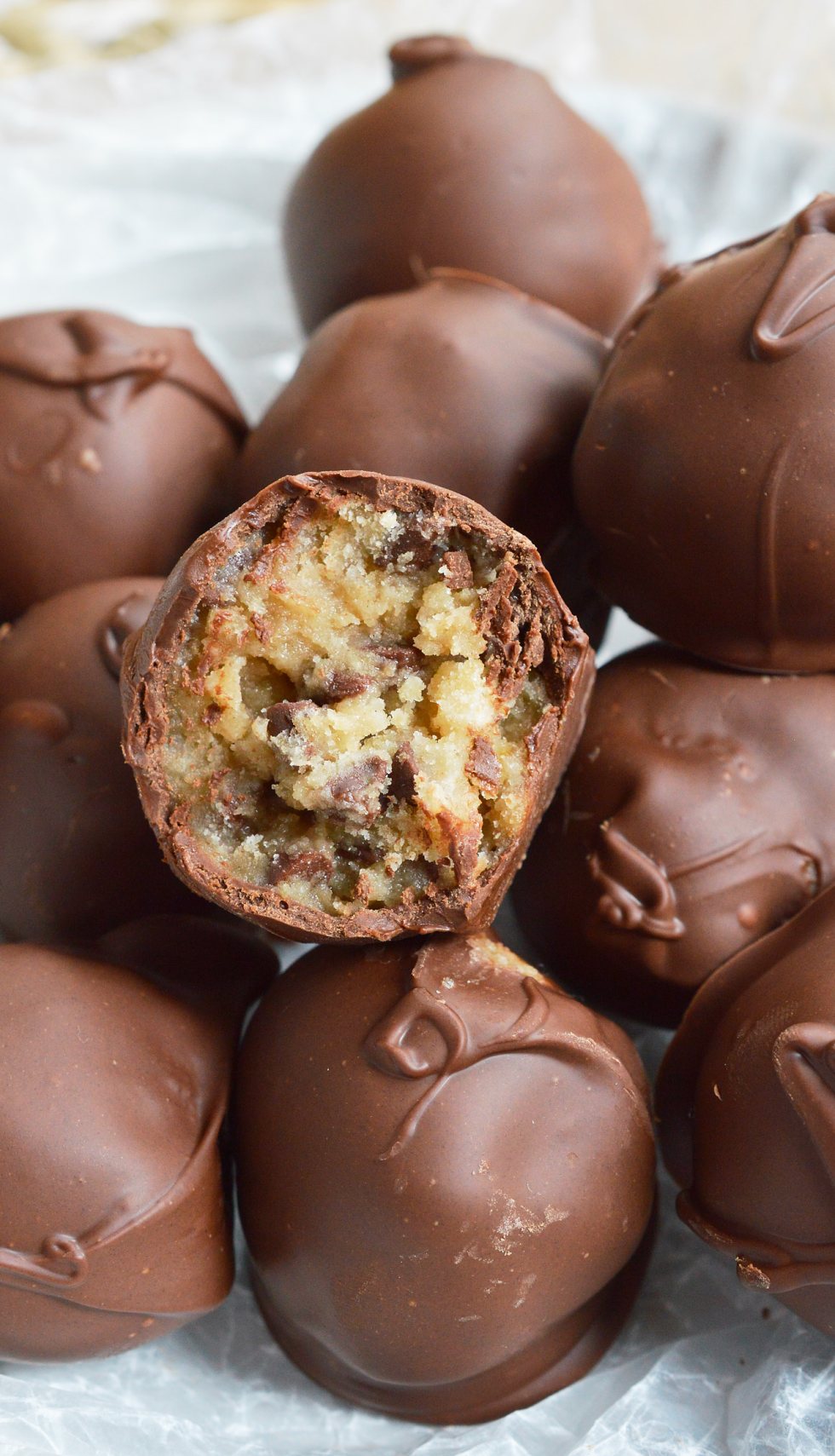 STOP what you're doing and make these Edible Cookie Dough Truffles! Chocolate chip cookie dough that is safe to eat is rolled into balls and coated with chocolate! This no-bake dessert recipe is as good as it gets!