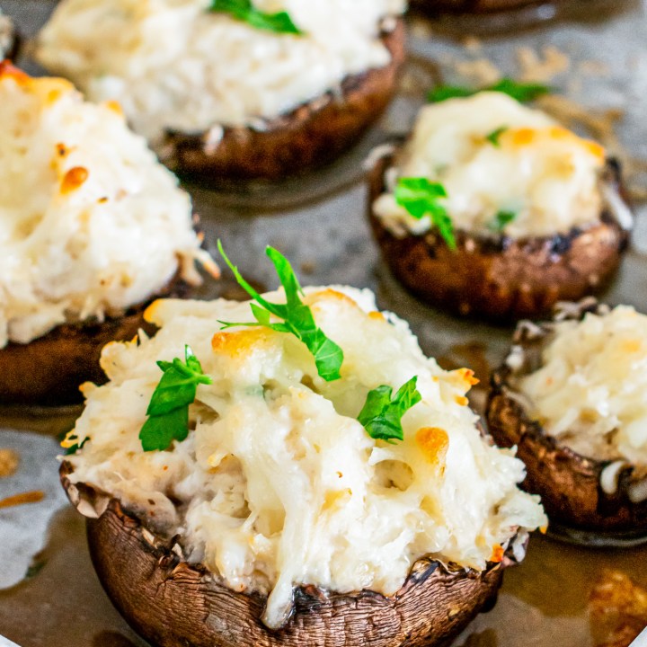 brown mushroom filled with creamy mixture topped with parsley