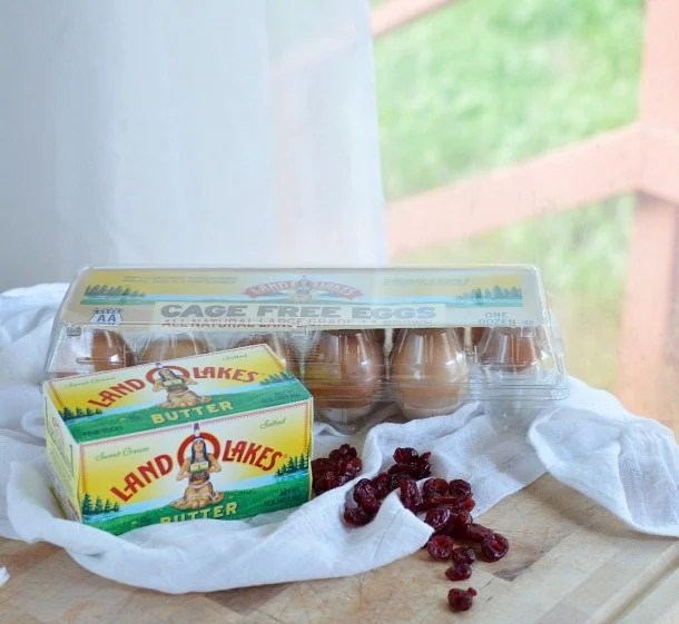 butter eggs and dried cranberries on cutting board