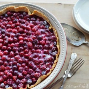 bright dark red cranberries in pie crust