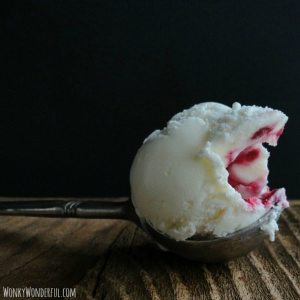 metal ice cream scoop topped with white and red ice cream