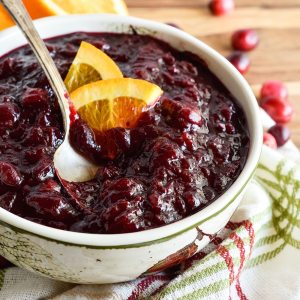 Slow Cooker Cranberry Sauce is an easy, no-fuss way to make this holiday favorite! Just mix ingredients, set your crockpot and move on with your life. Delicious, homemade cranberry sauce will be ready and waiting!