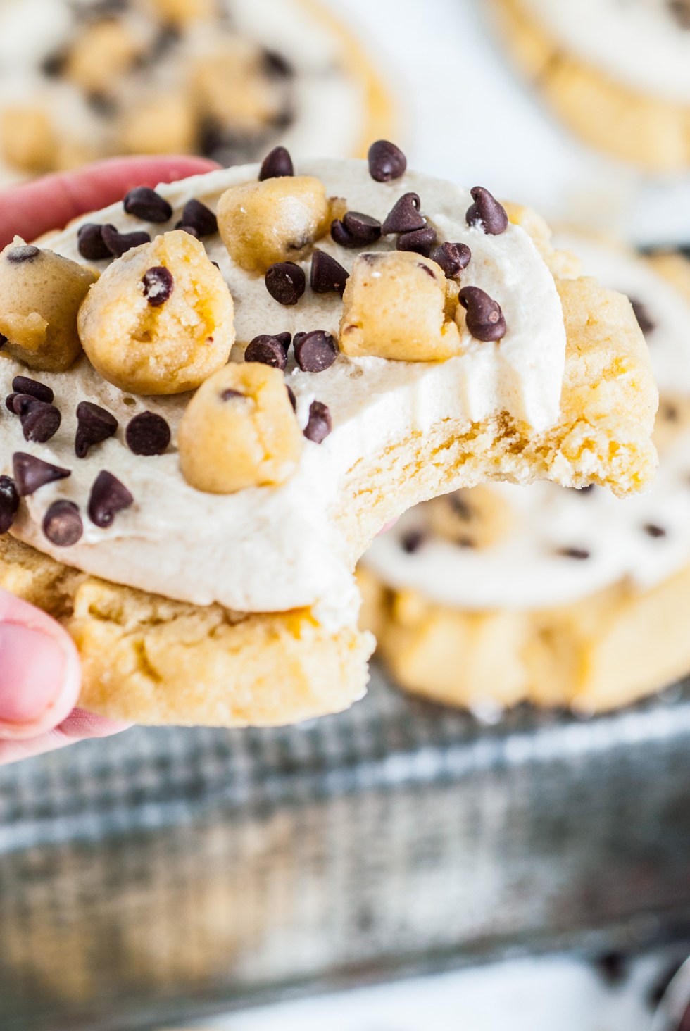 hand holding cookie with bite taken out