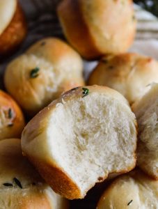 These Easy Yeast Rolls are a great addition to any feast! Perfectly sized rolls, baked in muffin tins then slathered with butter and fresh thyme. Nothing beats fresh baked bread!