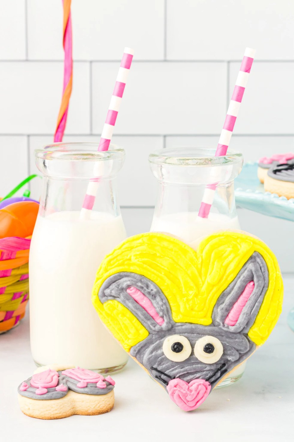 bunny cookie next to glasses of milk