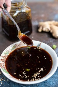 teriyaki sauce dripping down from spoon into small bowl