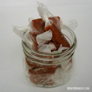 jar filled with caramels wrapped with wax paper