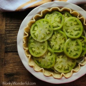 overhead view of sliced green tomatoes in pie crust