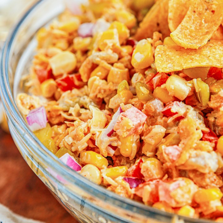 corn salad in bowl topped with Fritos