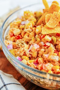 corn salad in bowl topped with Fritos