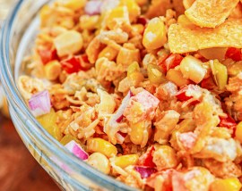 corn salad in bowl topped with Fritos