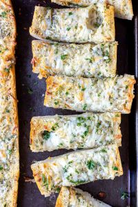 sliced baked garlic bread on baking sheet