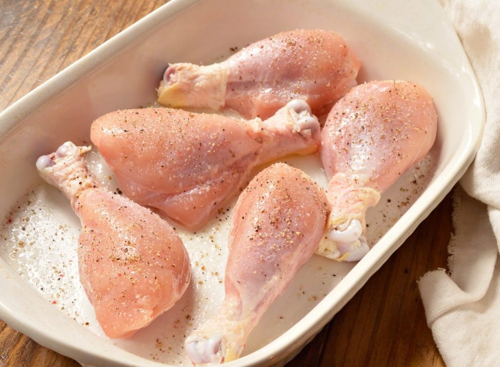 raw chicken in roasting pan