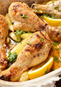 buttery lemon garlic chicken drumsticks in roasting pan