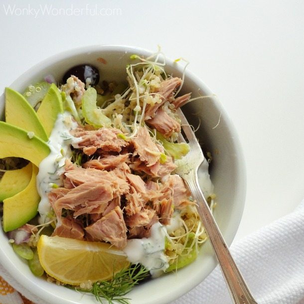 tuna, quinoa, avocado and fork in white bowl