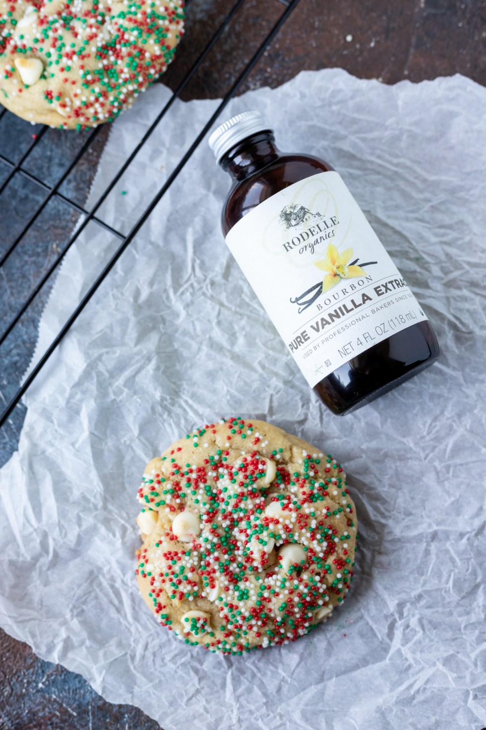 container of vanilla extract next to cookie