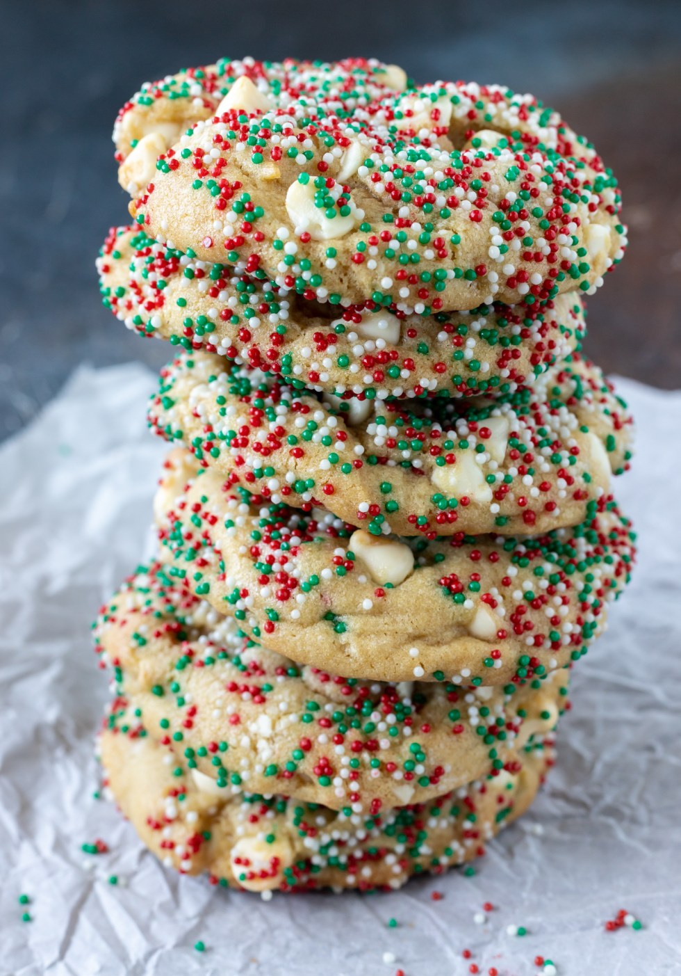 stack of golden cookies covered in sprinkles