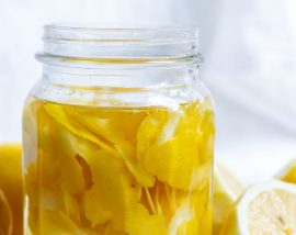 lemon peels and clear vinegar in glass jar