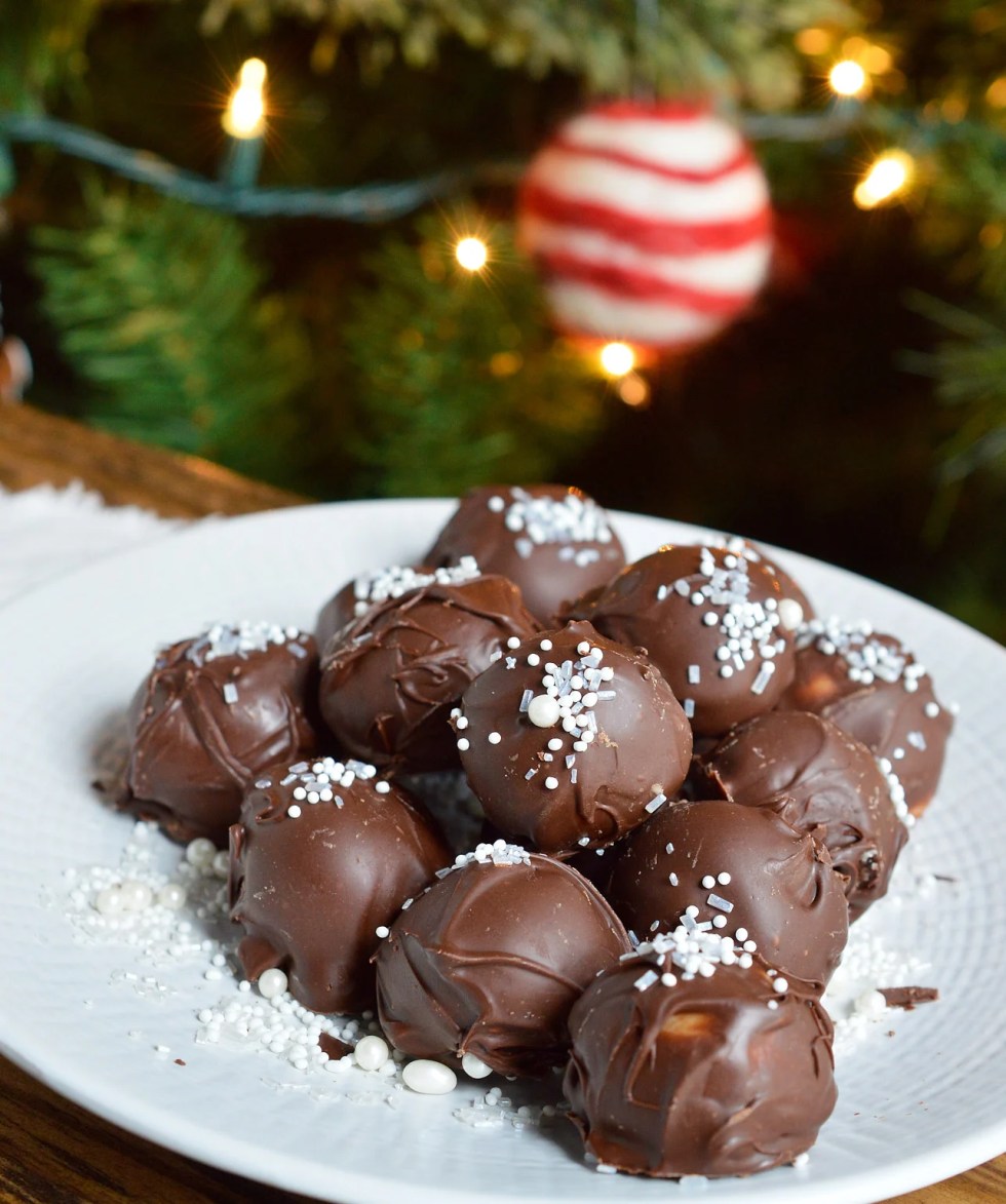 It's time for holiday treat platters and homemade gifts. These Peppermint Pattie Chocolate Truffles will be the star of any Christmas dessert tray! Cool peppermint filling is shaped into balls and coated with chocolate then topped with sprinkles.