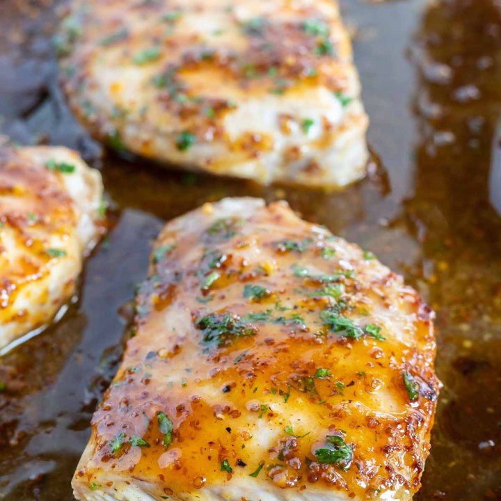 sliced pork chop on rimmed baking sheet