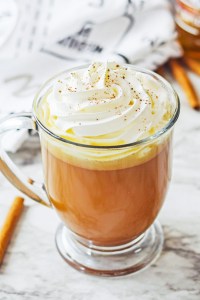 orange colored drink in clear mug