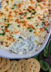 melty spinach dip in white casserole dish